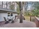 Spacious deck with outdoor dining set, surrounded by mature trees and greenery at 2031 Audubon Ne Dr, Atlanta, GA 30329