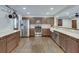 Modern kitchen featuring stainless steel appliances, wooden cabinets, and an open layout with hardwood floors at 2031 Audubon Ne Dr, Atlanta, GA 30329