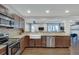 A kitchen showing stainless appliances, a farmhouse sink, and an open transition to a Gathering room at 2031 Audubon Ne Dr, Atlanta, GA 30329