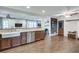 A kitchen showing stainless appliances, wood cabinets, and an open transition to a Gathering room with ceiling fans at 2031 Audubon Ne Dr, Atlanta, GA 30329