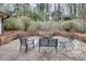 Inviting brick patio with string lights, surrounded by mature trees and greenery at 2031 Audubon Ne Dr, Atlanta, GA 30329