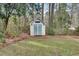 Backyard storage shed with double doors and window detail next to a wooden fence at 2031 Audubon Ne Dr, Atlanta, GA 30329