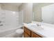 Bright bathroom featuring a tub and shower combo with a white tiled surround and a single sink vanity at 3326 Waldrop Trl, Decatur, GA 30034