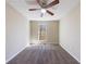 Cozy bedroom with neutral walls and carpeting, light-filled from window, and ceiling fan at 3326 Waldrop Trl, Decatur, GA 30034