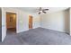 Large bedroom with ceiling fan, neutral walls, and attached bathroom at 3326 Waldrop Trl, Decatur, GA 30034