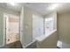 Bright hallway with neutral walls, closet, and views into bathroom and bedroom at 3326 Waldrop Trl, Decatur, GA 30034