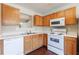 Efficient kitchen setup with light wooden cabinets, essential appliances, and ample counter space for cooking at 3326 Waldrop Trl, Decatur, GA 30034