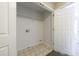 Laundry closet features washer/dryer hookups, storage shelf, and tile flooring at 3326 Waldrop Trl, Decatur, GA 30034