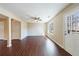 Sun-filled living room with hardwood floors, ceiling fan, and a white exterior door at 3326 Waldrop Trl, Decatur, GA 30034