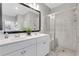 Bright and airy bathroom with double sinks, a glass shower, and ample counter space at 3893 Shelleydale Dr, Powder Springs, GA 30127