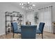 Dining room with modern chandelier, large windows and open shelving at 3893 Shelleydale Dr, Powder Springs, GA 30127