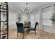 Contemporary dining room illuminated by a stylish modern chandelier at 3895 Shelleydale Dr, Powder Springs, GA 30127