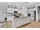 Modern kitchen featuring white cabinetry, stainless steel appliances, a granite countertop island and wooden floors at 3895 Shelleydale Dr, Powder Springs, GA 30127