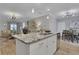 Modern kitchen showcasing a granite island, stainless steel dishwasher, and open layout to the living room at 3893 Shelleydale Dr, Powder Springs, GA 30127