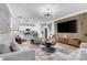 Modern living room showcasing a chic decor, open layout, and a sleek entertainment center with a wall-mounted TV at 3895 Shelleydale Dr, Powder Springs, GA 30127