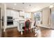 Modern kitchen featuring white cabinets, an island, stainless steel appliances, and hardwood floors at 4225 Sharpton Park Dr, Auburn, GA 30011