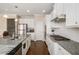 Well-lit eat-in kitchen featuring granite countertops, stainless steel appliances, and hardwood floors at 4225 Sharpton Park Dr, Auburn, GA 30011