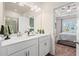 A bathroom with a double vanity with white cabinets and the main bedroom in the background at 319 Skye Ln # 52, Cartersville, GA 30121