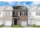 New two-story townhome with brick facade, lawn, and attached one car garage at 319 Skye Ln # 52, Cartersville, GA 30121