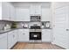 Well-lit kitchen featuring stainless steel appliances and white cabinets at 319 Skye Ln # 52, Cartersville, GA 30121