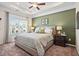The main bedroom has a tray ceiling, a large window, carpeted floors and a decorative green accent wall at 319 Skye Ln # 52, Cartersville, GA 30121