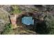 Aerial view of the house showing the detached garage and yard surrounded by trees at 5500 Rockbridge Road, Stone Mountain, GA 30088