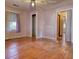 Bright bedroom with wood floor, closet, ceiling fan, and natural light from the window at 5500 Rockbridge Road, Stone Mountain, GA 30088