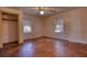Bright bedroom featuring hardwood floors, neutral walls, closet, and two windows at 5500 Rockbridge Road, Stone Mountain, GA 30088