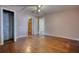 Large bedroom features hardwood floors, closet, ceiling fan, and multiple entryways at 5500 Rockbridge Road, Stone Mountain, GA 30088