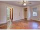 Bedroom boasts hardwood floors, a ceiling fan, closet, and access to an ensuite at 5500 Rockbridge Road, Stone Mountain, GA 30088