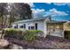 This house features a screened in porch and mature landscaping at 5500 Rockbridge Road, Stone Mountain, GA 30088