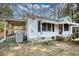 This home features a covered porch and mature landscaping at 5500 Rockbridge Road, Stone Mountain, GA 30088