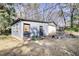 Exterior of the property with two doors, garage, small windows and surrounding trees at 5500 Rockbridge Road, Stone Mountain, GA 30088