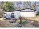 Exterior view of a garage with a white door and two entrances surrounded by a small garden at 5500 Rockbridge Road, Stone Mountain, GA 30088