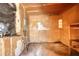 Interior of the garage featuring worn paneling, concrete flooring, and some shelving at 5500 Rockbridge Road, Stone Mountain, GA 30088