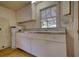 Kitchen features neutral countertop, ample cabinet space, window, and water heater unit at 5500 Rockbridge Road, Stone Mountain, GA 30088