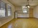Kitchen is equipped with ample cabinet space, neutral countertop, and three large windows at 5500 Rockbridge Road, Stone Mountain, GA 30088