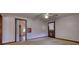 This room features carpet, a fan, and a door to another room at 5500 Rockbridge Road, Stone Mountain, GA 30088