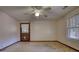 This room features carpet, a fan, and a window at 5500 Rockbridge Road, Stone Mountain, GA 30088