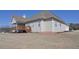 Large home featuring a backyard deck and an expansive lawn on a bright day at 108 Jasmine Way, Villa Rica, GA 30180