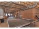Spacious unfinished basement with exposed wood beams and some furniture. Great for storage or recreation at 108 Jasmine Way, Villa Rica, GA 30180