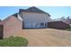 View of walkout basement featuring brick wall surround, garage and multiple doors for convenient access at 108 Jasmine Way, Villa Rica, GA 30180