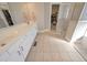 Bathroom featuring double sinks, a walk-in shower, and a large walk-in closet at 108 Jasmine Way, Villa Rica, GA 30180