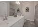 Well-lit bathroom with double vanity, tile floors, decorative mirror and wreath at 108 Jasmine Way, Villa Rica, GA 30180
