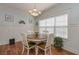 Cozy dining area with wood floors, natural light, and a charming chandelier above a round table with seating at 108 Jasmine Way, Villa Rica, GA 30180