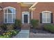 Close-up of the front door highlighting the arched windows and beautiful brickwork at 108 Jasmine Way, Villa Rica, GA 30180