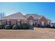 Charming brick home featuring manicured landscaping and a well-maintained lawn at 108 Jasmine Way, Villa Rica, GA 30180