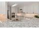 A close-up shot of a kitchen featuring white cabinetry, granite countertops, and stainless steel appliances at 108 Jasmine Way, Villa Rica, GA 30180