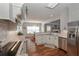 Bright kitchen view to dining area featuring white cabinets, granite countertops, stainless appliances, and wood floors at 108 Jasmine Way, Villa Rica, GA 30180