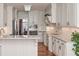 Bright kitchen with white cabinets, granite countertops, and stainless steel appliances at 108 Jasmine Way, Villa Rica, GA 30180
